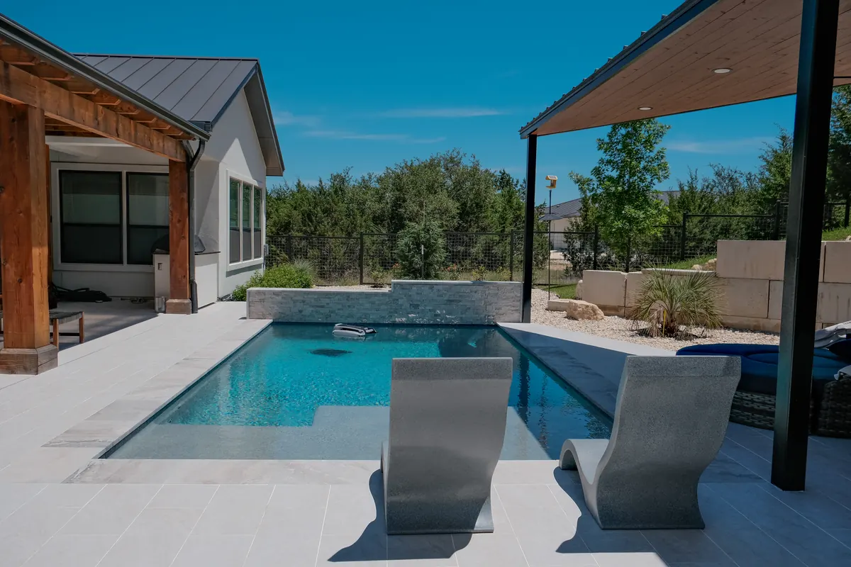 Pool and shallow sun shelf between the house and pavilion