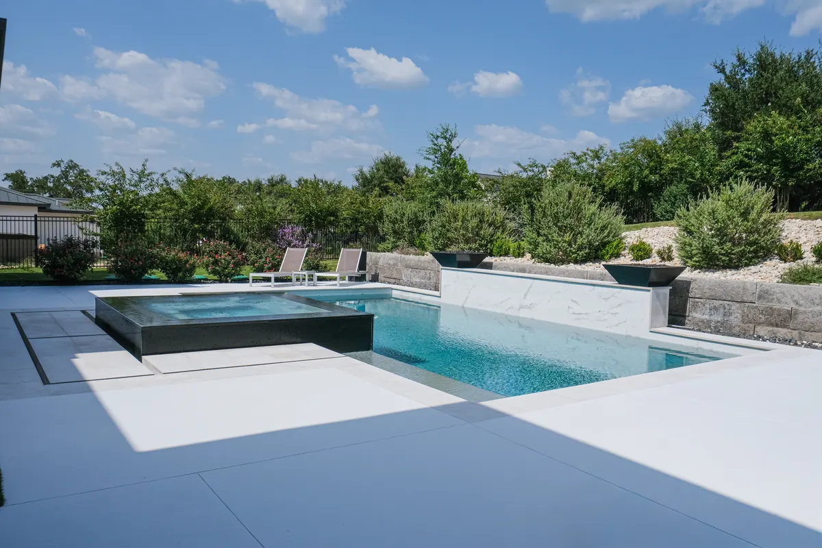 Geometric pool and spa with a pale feature wall